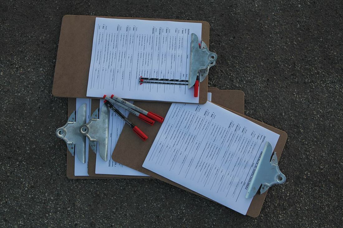 Clipboards with checklists and pens